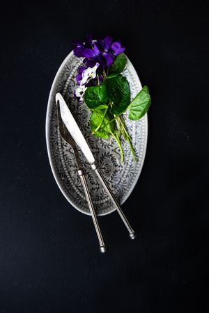 Top view of table setting for Easter dinner with delicate purple flowers