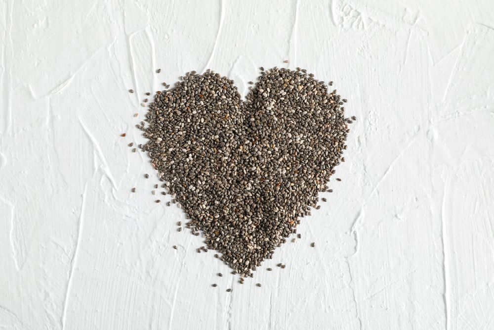 Heart layout of chia on neutral background, copy space