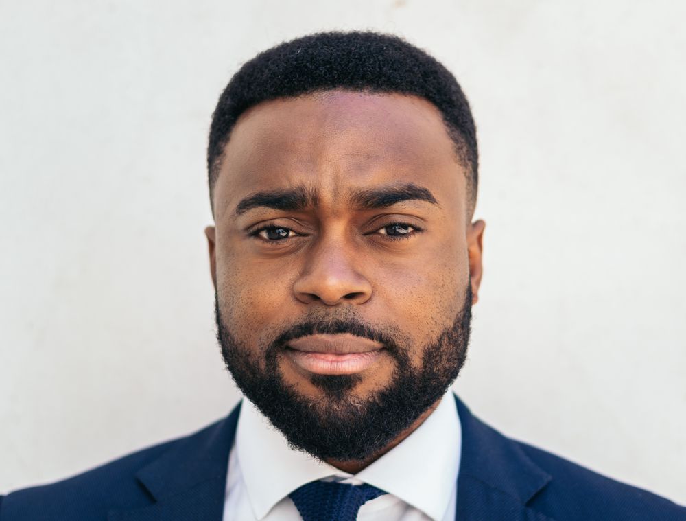 Close-up of a confident Black businessman looking at camera