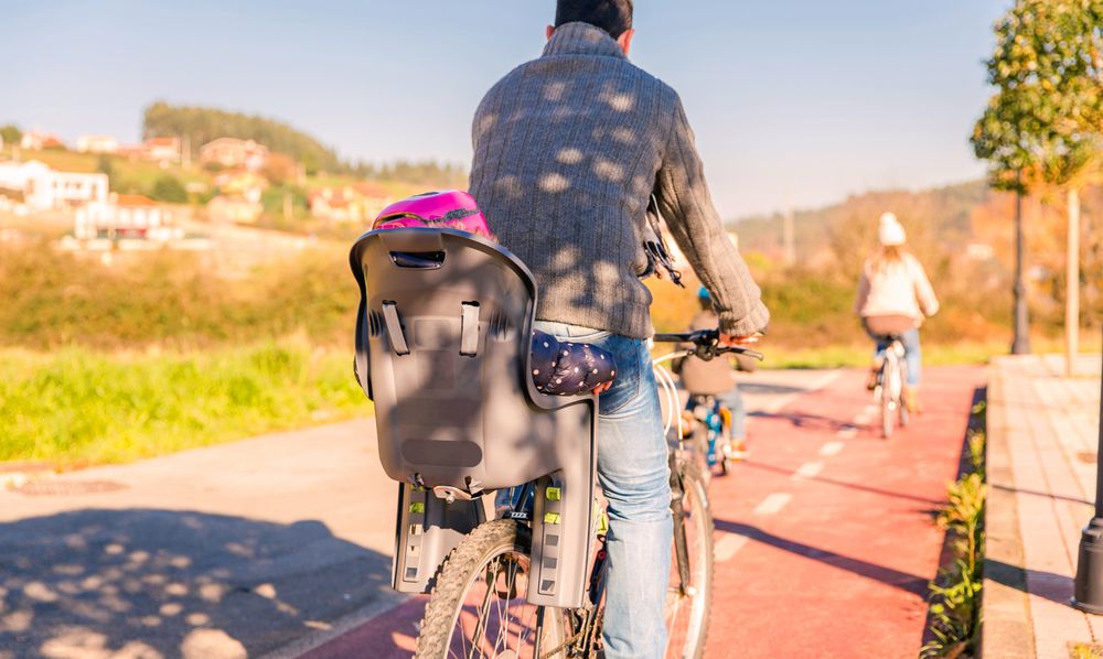 Back of baby seat on bike on family ride