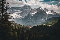 Snow covered mountain under cloudy sky