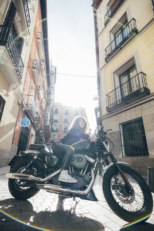 Young woman in custom motorbike