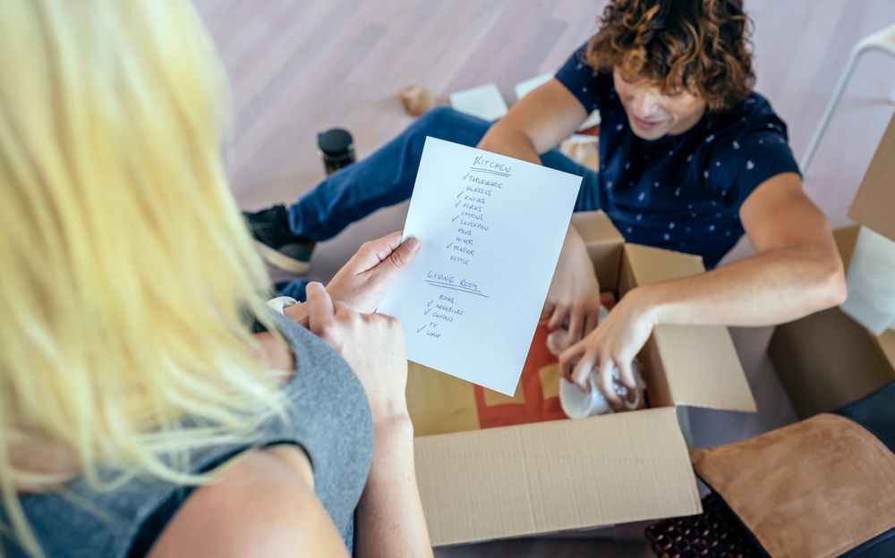 Couple unpacking moving boxes
