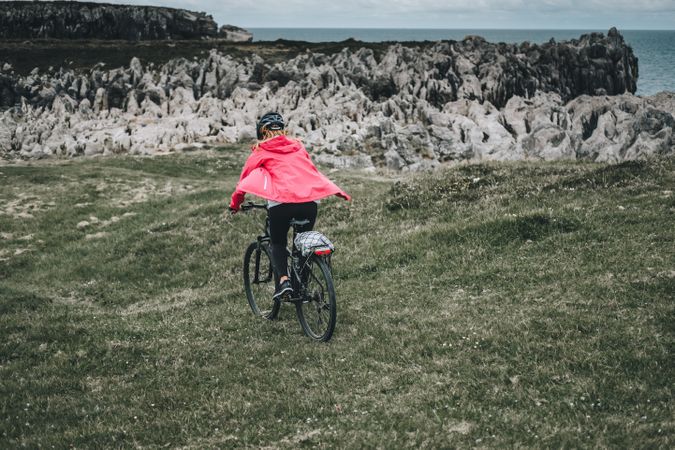 Female cyclist riding on mountain road