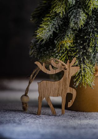 Close up of Christmas card concept of mini tree and reindeer ornament