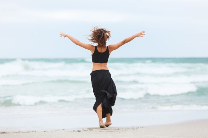 woman dancing near sea
