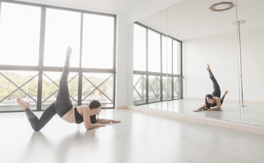 Flexible female stretching in studio