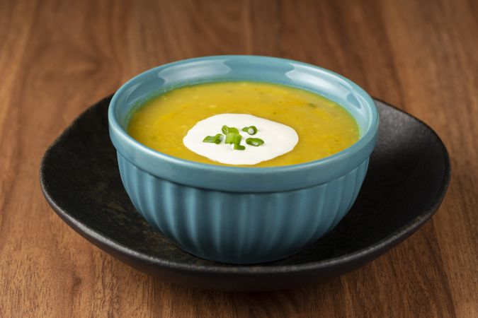 Bowl with pumpkin soup on the table.