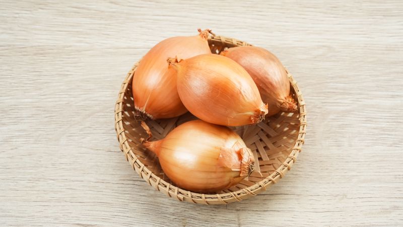 Fresh onion on bamboo plate