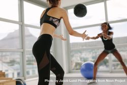 Women exercising with medicine ball in gym 0v3R6B