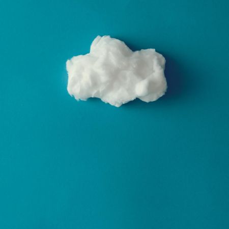 Cloud made out of cotton wool on blue background