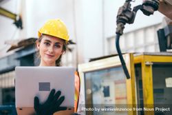 Female industrial engineer or technician worker in hard helmet with laptop 0LZjR4