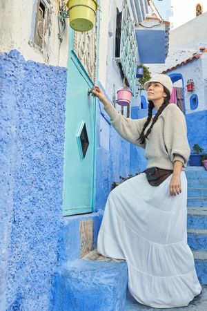 Woman on steps between ancient buildings