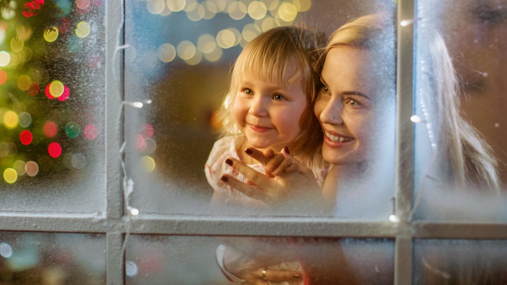 On Christmas Eve Mother and Daughter Looking Through Window.