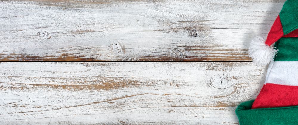 Christmas Elf hat on rustic knotty wooden background