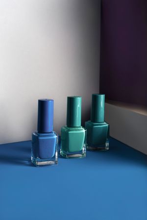 Multi-colored nail polish on pastel colors geometric pattern background