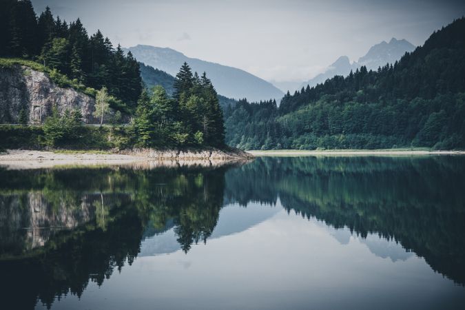 Trees surrounding lake with reflection on water