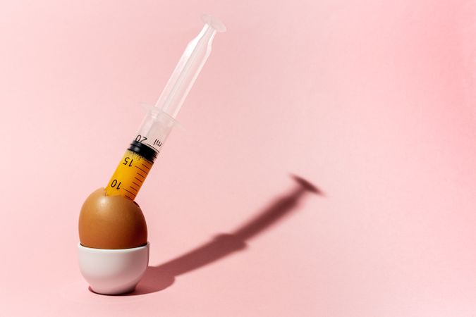 Egg with syringe in eggcup