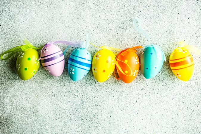 Easter card concept with line of colorful egg ornaments