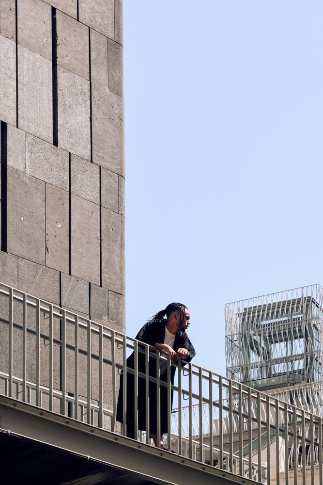 Black male standing on bridge