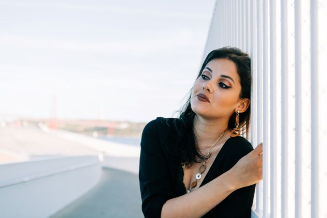 Trendy female standing on urban background