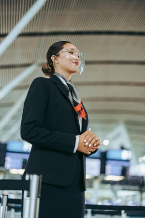 Airport attendant standing during pandemic
