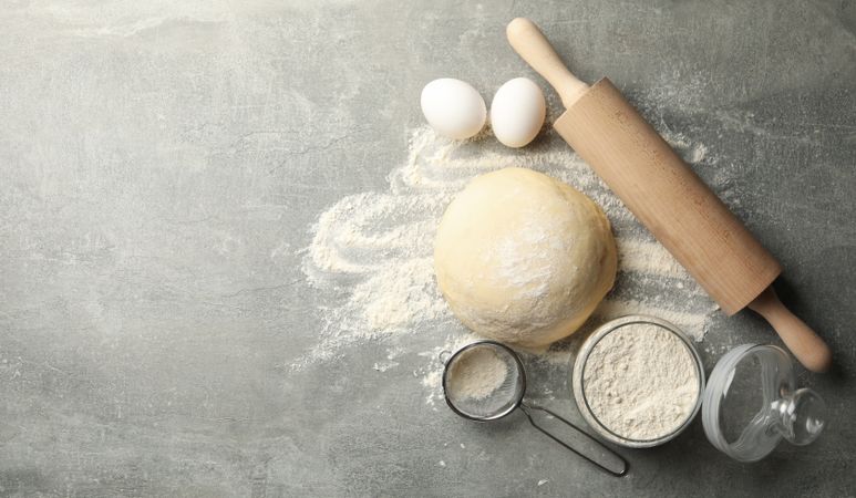 Concept for baking with dough on gray background