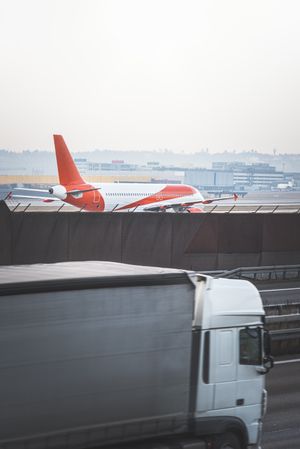 Airplane on runway and truck in motion blur