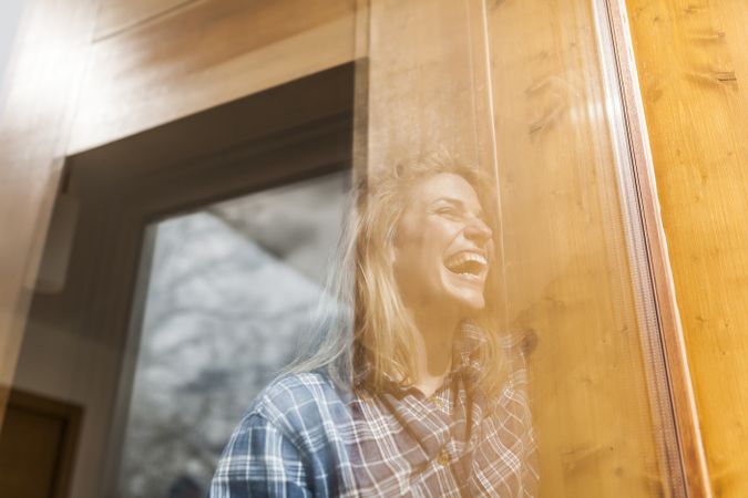 Woman reflection in a windows at home