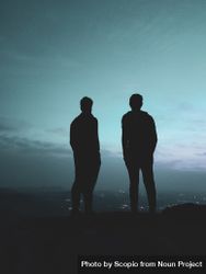 Silhouette of two men standing on hill 0yORn4