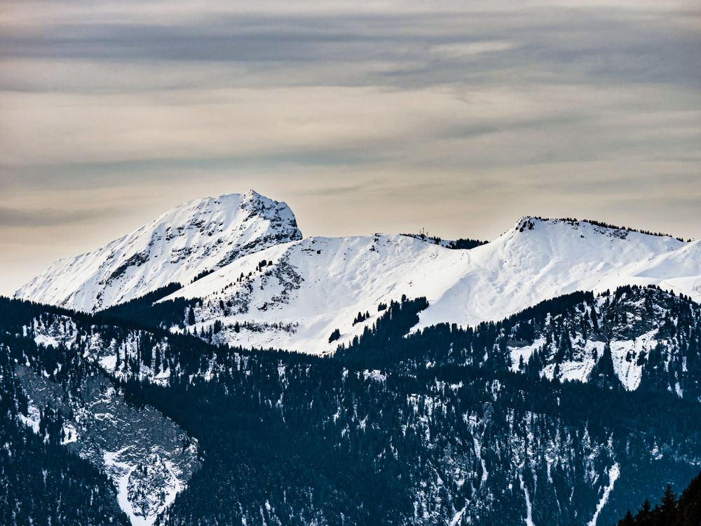 Swiss Alps winter landscape with snow and sun, mountains in Europe