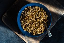 Top view of blue bowl of breakfast cereals