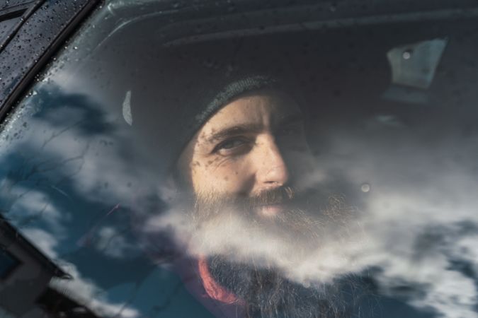 Smiling man sitting in car
