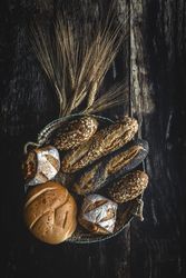 Assorted gold homemade bread on dark wood background