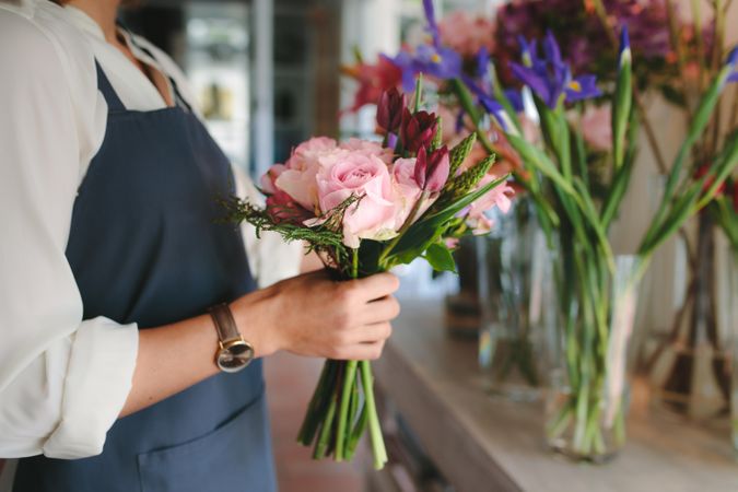 Close up of female florist hands holding flowers