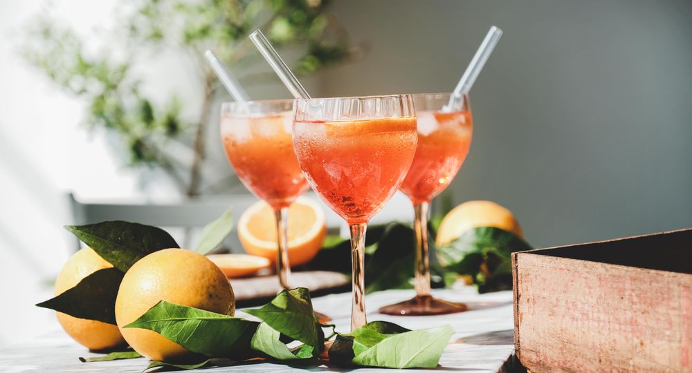 Three Aperol Spritz aperitif alcohol drink in glasses, horizontal