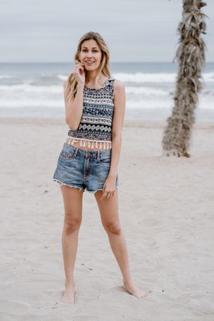 Happy female laughing on sandy beach