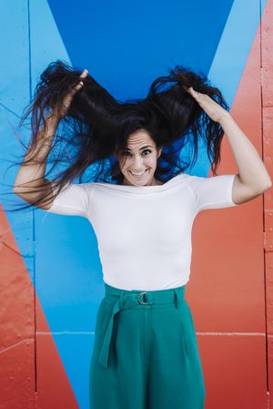 A young woman holding her disheveled hair