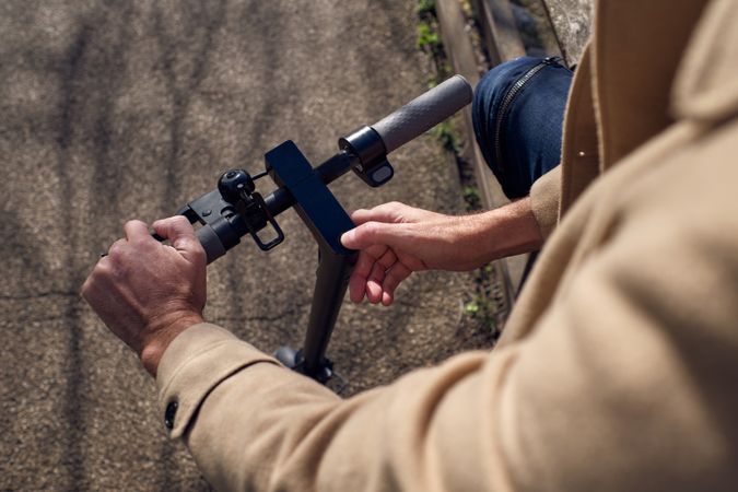 Unrecognizable man using display of scooter
