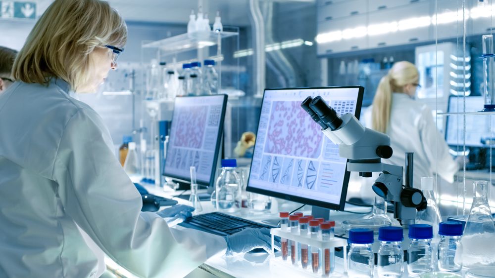 Mature Female Scientist Works with High Tech Equipment in a Modern Laboratory.