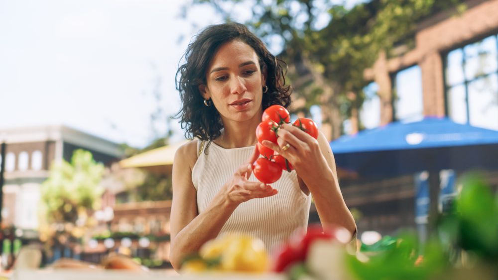 Brazilian Female Customer Buying Sustainable Organic Tomatoes From a Local Farmers Stall