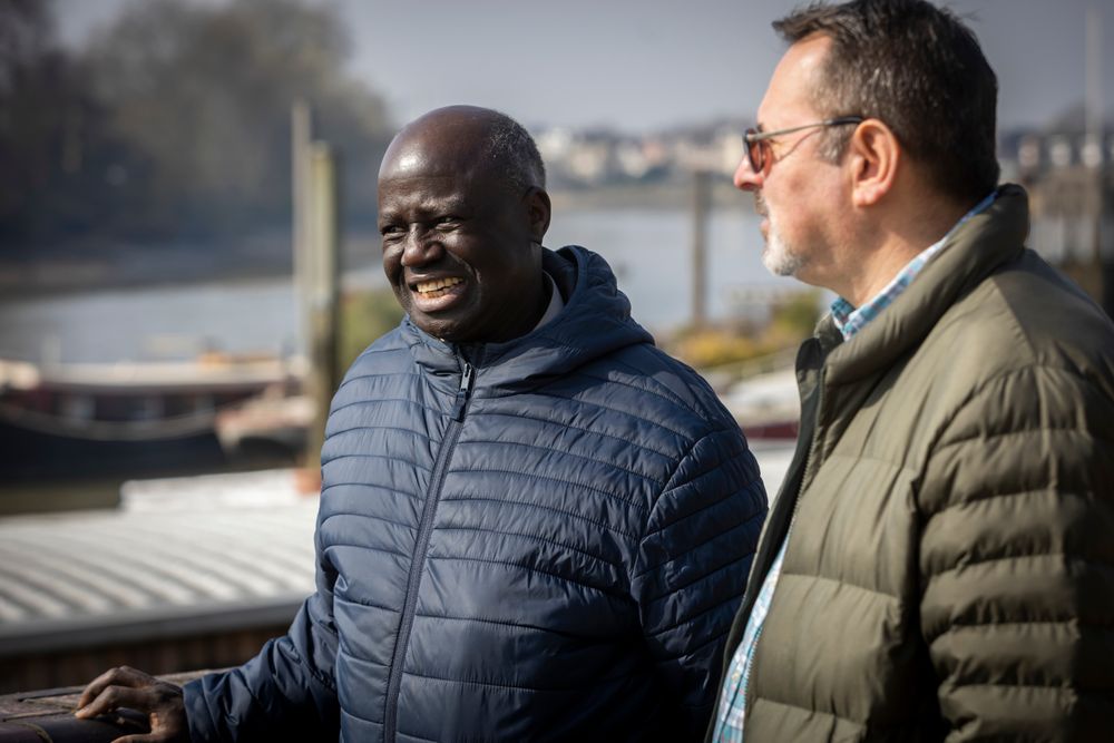 Two men chatting by the river