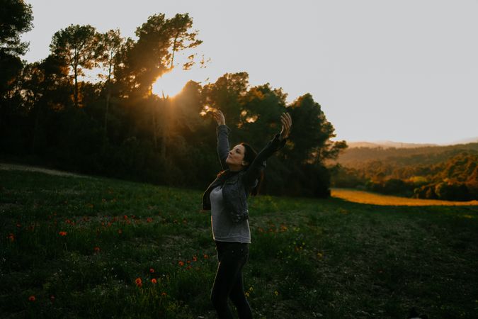 Woman walking on meadow and enjoying freedom