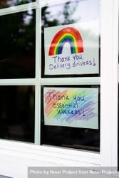 Close up of two hand lettered signs with rainbows showing gratitude during quarantine 5kRJ60