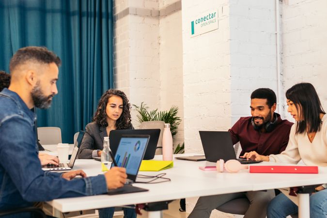 Group of multiracial people working with laptop in a coworking