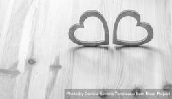 Two gray hearts on wooden table bEMznb