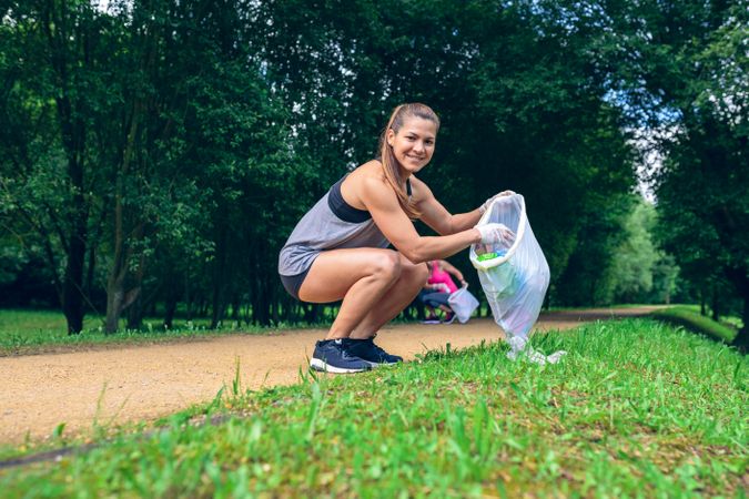 Woman with garbage bag doing plogging