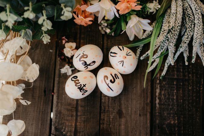 Easter eggs hand painted by children with messages in a wooden table