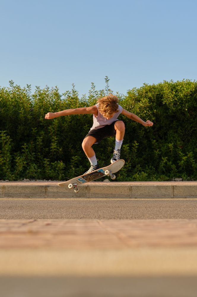 Energetic skater jumping with skateboard