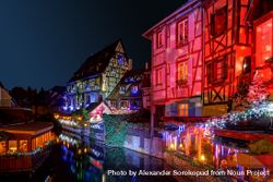 Buildings along river in Alsace, France lit up for Christmas bY8yD4